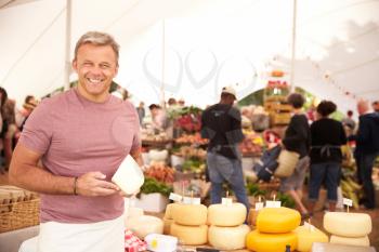 Man Selling Fresh Cheese At Farmers Food Market