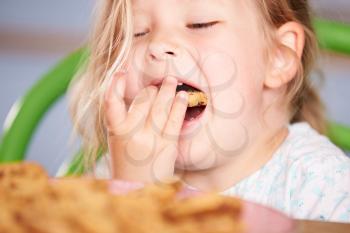 Close Up Of Girl Eating Chocolate Chip Cookie