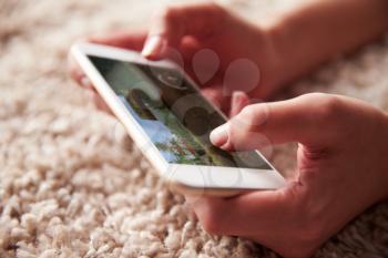 Close up of persons hands playing a game on a smartphone