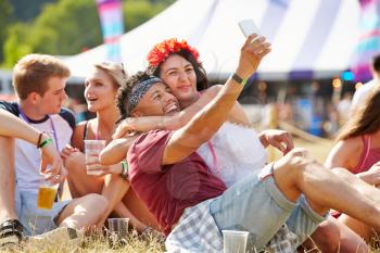 Friends taking selfie at a music festival