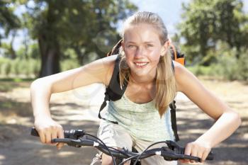 Teenage Girl Cycling Through Countryside