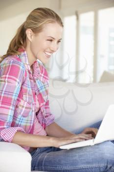 Young Woman Using Laptop Computer At Home
