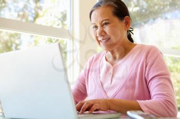 Senior Taiwanese woman working on laptop