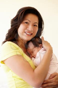 Vietnamese mother cuddling baby