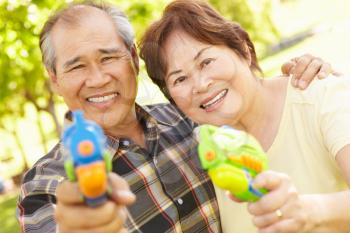 Senior couple with water pistols