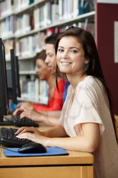 Girl working on computer in library