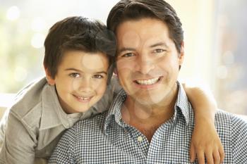 Portrait Of Hispanic Father And Son At Home