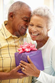 Senior man giving gift to wife