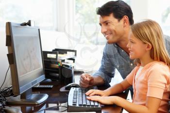 Father and daughter using skype in home office
