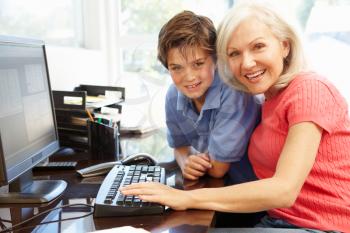 Mid age woman and grandson using computer