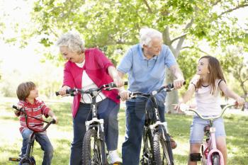 Senior couple with grandchildren on bikes