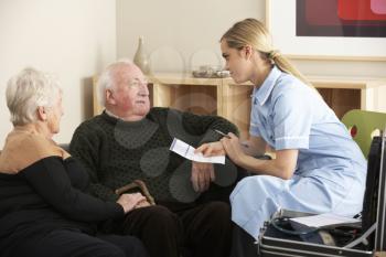 Nurse visiting senior couple at home