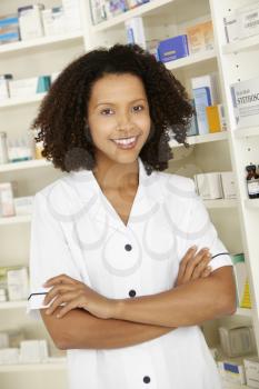 Female nurse standing in UK pharmacy