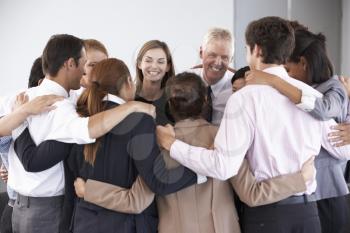 Group Of Businesspeople Bonding In Circle At Company Seminar