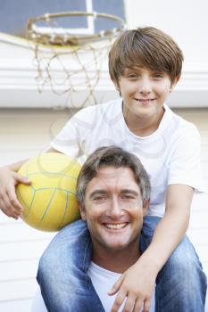 Father And Son Family Playing Basketball Outside Garage