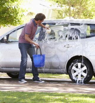 Man Washing Car In Drive
