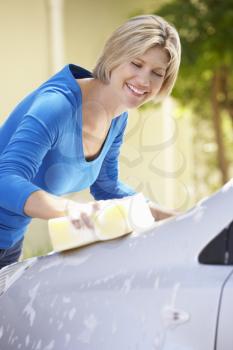 Woman Washing Car In Drive