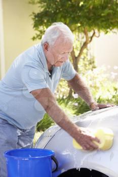 Senior Man Washing Car In Drive