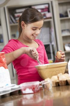 Girl Preparing Ingredients To Bake Cakes In Kitchen