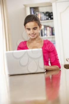 Girl Using Laptop Computer At Home
