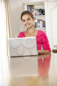 Girl Using Laptop Computer At Home