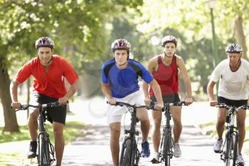 Group Of Men On Cycle Ride Through Park