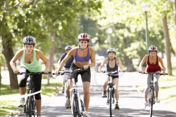 Group Of Women On Cycle Ride Through Park