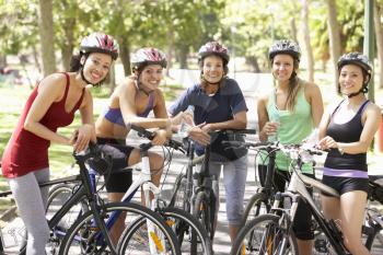 Group Of Women Resting During Cycle Ride Through Park