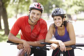 Portrait Of Couple On Cycle Ride Through Park