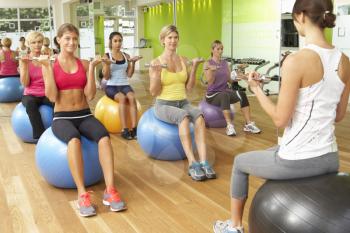 Women Taking Part In Gym Fitness Class