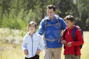Father With Children On Hike In Beautiful Countryside