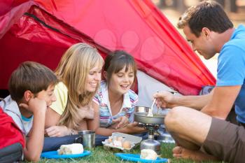 Family Cooking Breakfast On Camping Holiday