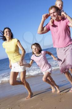 Family Running Along Beach Together