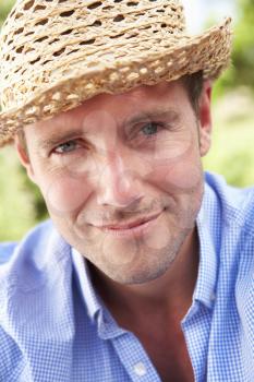 Head And Shoulders Portrait Of Smiling Man With Sun Hat