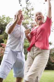 Energetic Senior Couple In Countryside