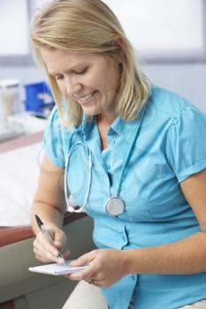 Female Doctor In Surgery Writing Out Prescription