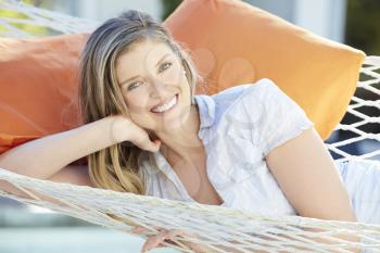 Attractive Woman Relaxing In Garden Hammock