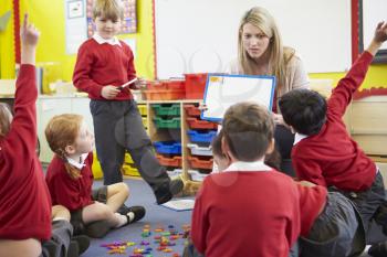 Teacher Teaching Spelling To Elementary School Pupils