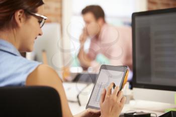 Businesswoman Using Digital Tablet In Creative Office