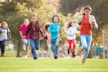 Group Of Young Children Running Towards Camera In Park