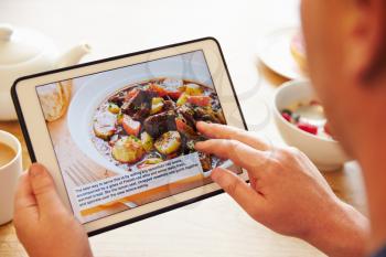 Person At Breakfast Looking At Recipe App On Digital Tablet