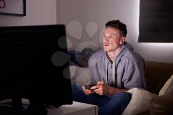 Young Man Addicted To Video Gaming At Home