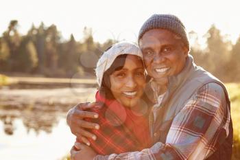 Portrait Of Senior African American Couple Walking By Lake
