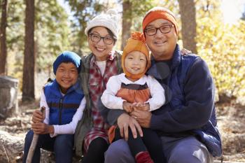 Portrait of Asian parents and two kids in a forest