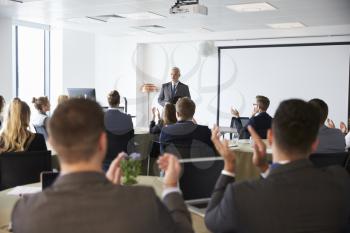 Mature Businessman Making Presentation At Conference