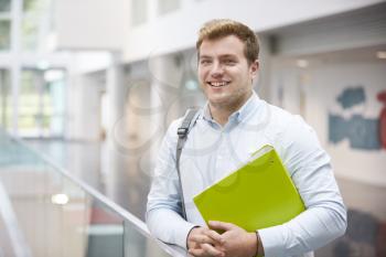 Smiling Caucasian male student in modern university building