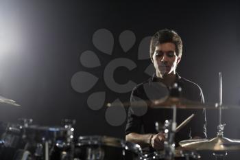 Young Drummer Playing Drum Kit In Studio