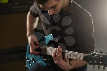 Man Playing Electric Guitar In Studio