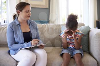 Young Girl With Problems Talking With Counselor At Home