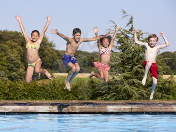 Group Of Children Jumping Into Outdoor Swimming Pool